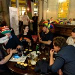 game devs answering quiz questions in silly hats and jumpers